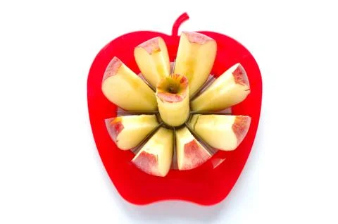 Apple cut into pieces with special cutting device on white background Stock Photos