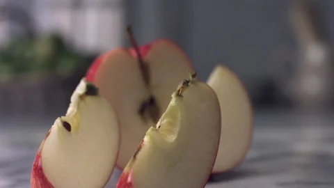 Apple cut in slices slow motion Video stock 120459555