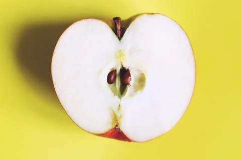 Apple cut on a yellow background. half apple Foto stock