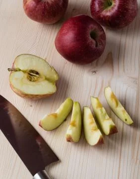 Apple on cuttingboard Stock Photos