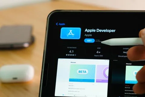 Apple Developer logo shown by apple pencil on the iPad Pro tablet screen. Man Stock Photos