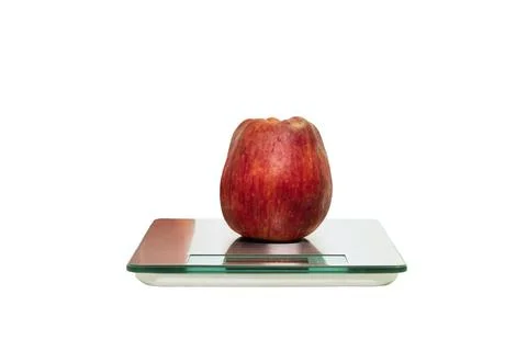 An apple on a digital scale on a white background Stock Photos