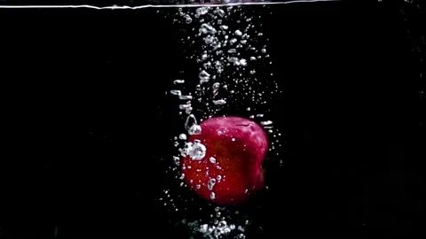 Apple dropping in the water slow motion in black background Stock Footage 159611914