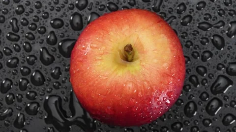 An apple in drops of water. Top view Stock Footage 181185834