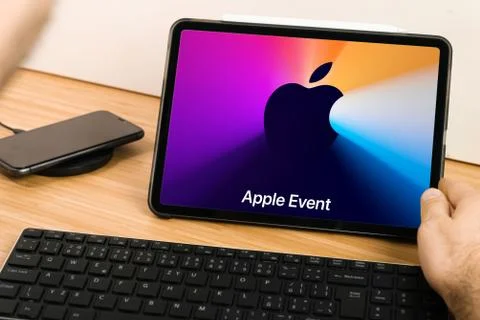 Apple Event Logo on the tablet screen. Man watching presentation from Apple Park Stock Photos