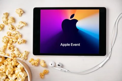 Apple Event Logo on the tablet screen. Man watching presentation from Apple Park Stock Photos