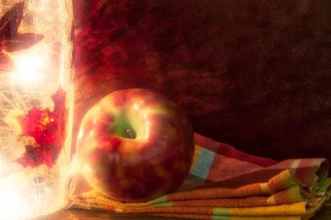 Apple in a fall theme with light and napkin and copy space. 스톡 사진