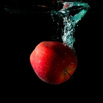 Apple falling to water Stock Photos
