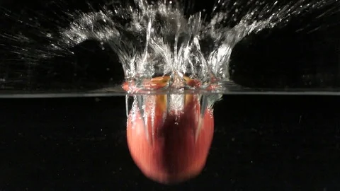 Apple falling into water in slow motion Stock Footage 88808779