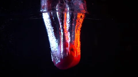 Apple falling in water super slow motion video against dark background Stock Footage 61421272