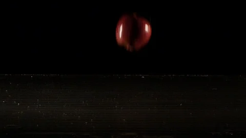 Apple falling on wet surface in slow motion Stock Footage 88802129
