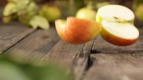 Apple Falling on Wooden Table and Splits into Quarters No. 1 Stock Footage 99137153