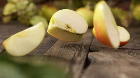Apple Falling on Wooden Table and Splits into Quarters No. 2 Stock Footage 99137173