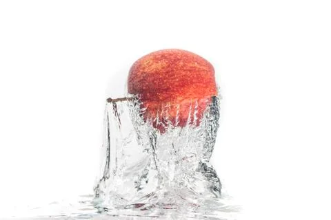 Apple falls under water with a splash. Stock Photos