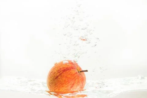 Apple falls under water with a splash. With lots of air bubbles Stock Photos