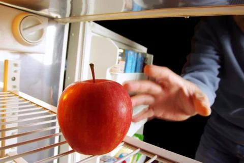 Apple on fridge Stock Photos