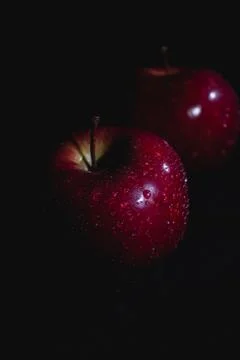Apple fruit with drops of water, abstract shadow, black background Foto stock