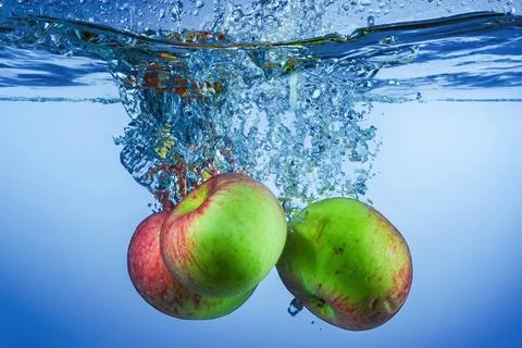 Apple Fruit Falling into the water Stock Photos