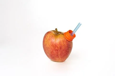 Apple, fruit on a white background, with a straw in the spout to be able to.. Stock Photos