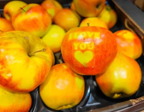 Apple in a full box of apples with I love You text sign for Valentine's day Фото