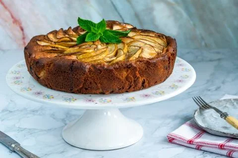 Apple, ginger and honey cake garnished with fresh mint Stock Photos