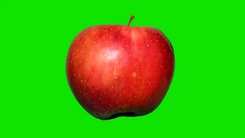 Apple on green backround Stock Footage 74023221