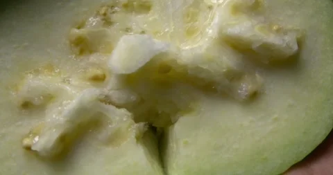 Apple guava being squeezed with hands, slow motion close-up Stock Footage 301017340