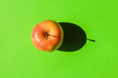 An Apple with a hard shadow on a plain background. the view from the top. blank Stock Photos