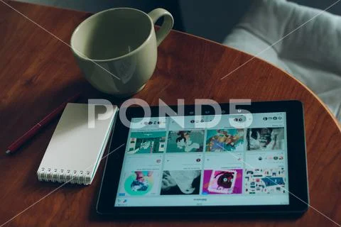 Apple iPad, cup of coffee and notebook on wood Stock Photos