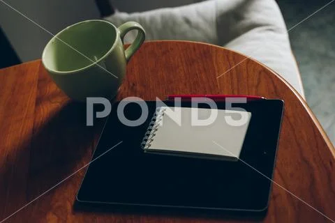 Apple iPad, cup of coffee and notebook on wood Stock Photos