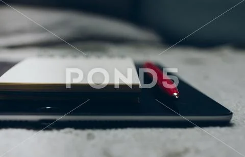 Apple iPad, pen and notebook on plaid Stock Photos