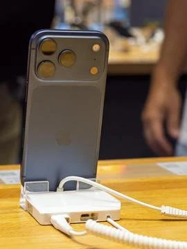 Apple iPhone 14 Pro Max Charging on Display Stand Stock Photos