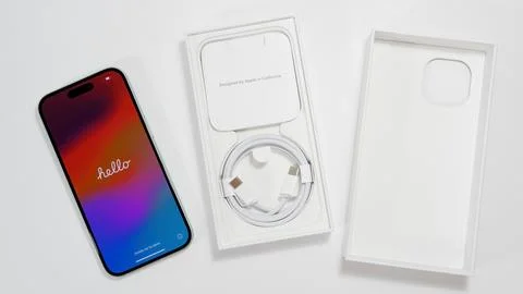 Apple iPhone 15 with Hello text welcome screen. Brand new iPhone in new green Stock Photos
