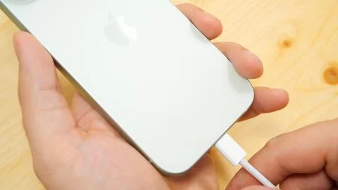 Apple iPhone 15 with USB-C cable charger. Apple's computers to USB-C. New iPhone Stock Photos