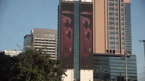 Apple iPhone 16 advertisement screen on a building in Bangkok, Thailand. Stockbeeldmateriaal 342437642