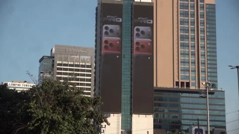 Apple iPhone 16 advertisement screen on a building in Bangkok, Thailand. Stock Footage 342437913