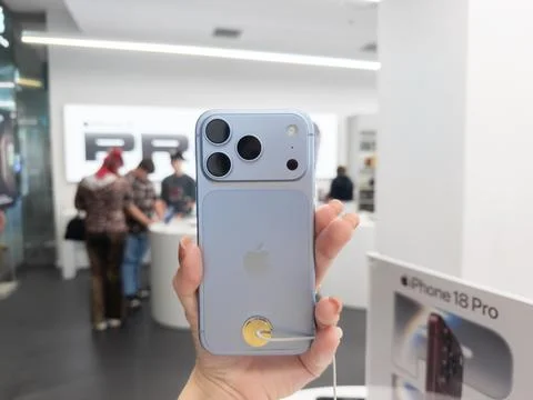 Apple iPhone 18 Pro in Glacier color held in hand at a retail store, Stock Photos