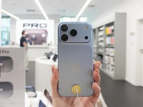 Apple iPhone 18 Pro Glacier color held in a retail shop, displaying the modern Stock Photos