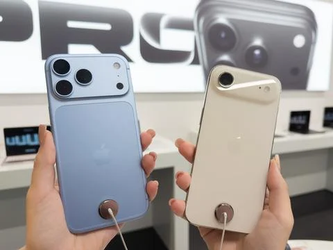 Apple iPhone 18 Pro in Glacier and iPhone Air in Light Gold held by a person in Stock Photos
