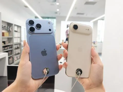 Apple iPhone 18 Pro in Glacier and Apple iPhone Air in Light Gold held by a Stock Photos