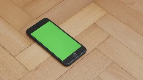 Apple Iphone 7 black device with greenscreen display Stock Footage 73621211