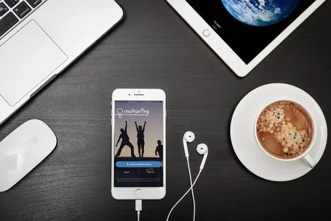 Apple iPhone 8 plus with Couchsurfing app on the screen Stock Photos