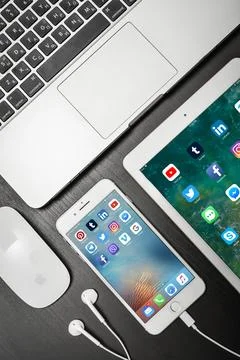 Apple iPhone 8 plus with social network apps on the screen with macbook, ipad Stock Photos