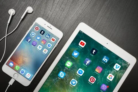 Apple iPhone 8 plus with social network apps on the screen with ipad Stock Photos