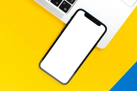 Apple iPhone mockup screen, flat lay office desk with laptop, yellow backgrou Stock Photos