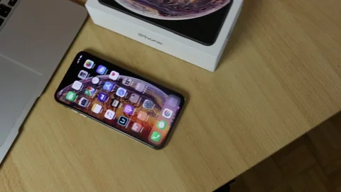 Apple iPhone Xs Max Gold and box with Apple Macbook Air Stock Footage 102378889