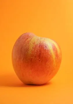 Apple isolated on orange background Stock Photos