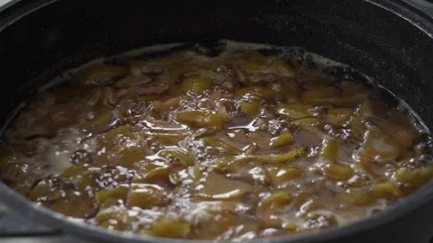 Apple jam boiling in a pan. Process of preparation sweet dessert from fresh Stock Footage 243003740