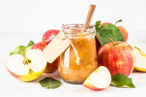 Apple jam with fresh apples on white background. Stock Photos