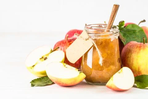 Apple jam with fresh apples on white background. Stock Photos